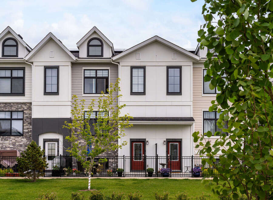 Discover modern living in this stunning townhouse complex, featuring a harmonious blend of stone and siding exteriors.