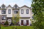 Discover modern living in this stunning townhouse complex, featuring a harmonious blend of stone and siding exteriors.