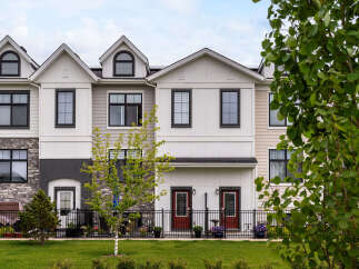 Discover modern living in this stunning townhouse complex, featuring a harmonious blend of stone and siding exteriors.