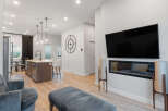 Experience modern living in this open-concept home featuring a sleek kitchen island with pendant lighting and bar seating.