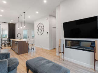Experience modern living in this open-concept home featuring a sleek kitchen island with pendant lighting and bar seating.