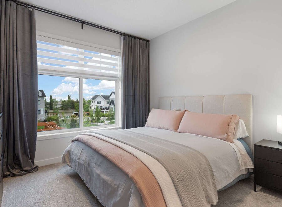 Experience comfort and style in this beautifully appointed bedroom, featuring a plush upholstered headboard and soft, inviting bedding.