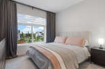 Experience comfort and style in this beautifully appointed bedroom, featuring a plush upholstered headboard and soft, inviting bedding.