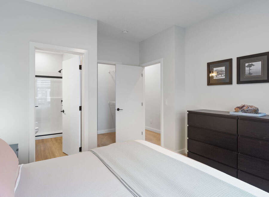 Step into this inviting bedroom, featuring a spacious walk-in closet and an en-suite bathroom with a modern shower.