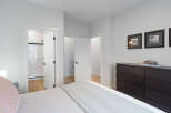 Step into this inviting bedroom, featuring a spacious walk-in closet and an en-suite bathroom with a modern shower.