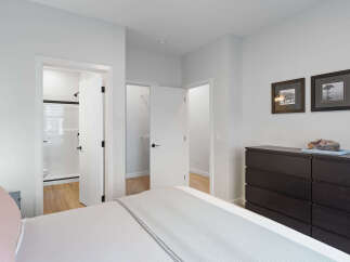 Step into this inviting bedroom, featuring a spacious walk-in closet and an en-suite bathroom with a modern shower.