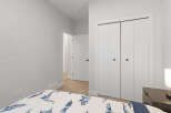 This bedroom features a comfortable bed with a playful dinosaur-themed comforter, perfect for a child's room.