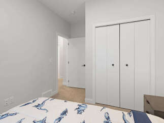 This bedroom features a comfortable bed with a playful dinosaur-themed comforter, perfect for a child's room.