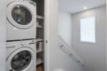 Discover modern convenience with this stacked washer and dryer unit, perfect for maximizing space in your laundry area.