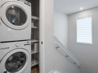 Discover modern convenience with this stacked washer and dryer unit, perfect for maximizing space in your laundry area.