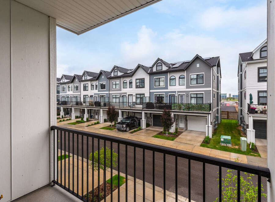 Discover modern living in this stunning townhouse complex, featuring a row of contemporary homes with striking architectural details.