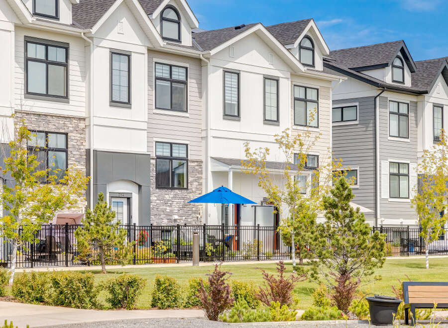 Discover modern townhome living in this stunning property featuring a contemporary exterior with mixed materials and sleek black-framed windows.