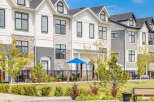 Discover modern townhome living in this stunning property featuring a contemporary exterior with mixed materials and sleek black-framed windows.