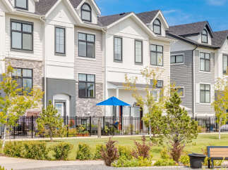 Discover modern townhome living in this stunning property featuring a contemporary exterior with mixed materials and sleek black-framed windows.