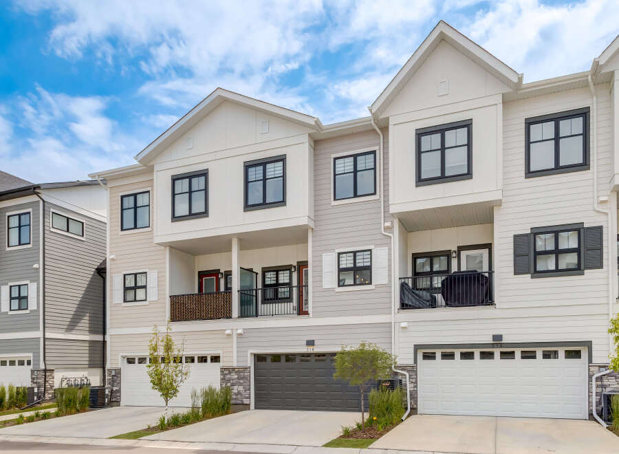 Discover modern townhome living with this stunning property featuring a sleek exterior and spacious multi-level design.