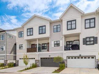 Discover modern townhome living with this stunning property featuring a sleek exterior and spacious multi-level design.