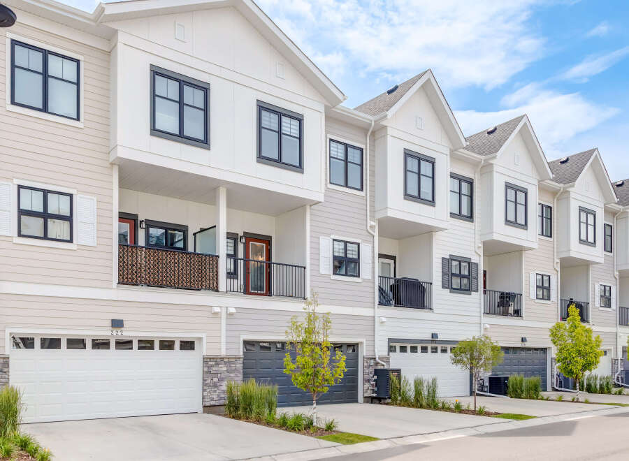 Discover modern townhome living with this stunning property featuring sleek architecture and multiple garage doors.