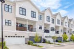 Discover modern townhome living with this stunning property featuring sleek architecture and multiple garage doors.