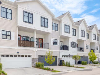 Discover modern townhome living with this stunning property featuring sleek architecture and multiple garage doors.