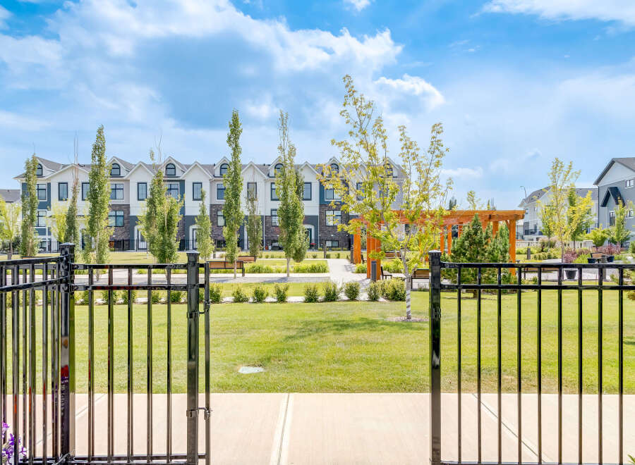 Discover modern living in this beautifully landscaped community, featuring stylish townhomes with elegant exteriors and manicured green spaces.