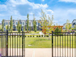 Discover modern living in this beautifully landscaped community, featuring stylish townhomes with elegant exteriors and manicured green spaces.