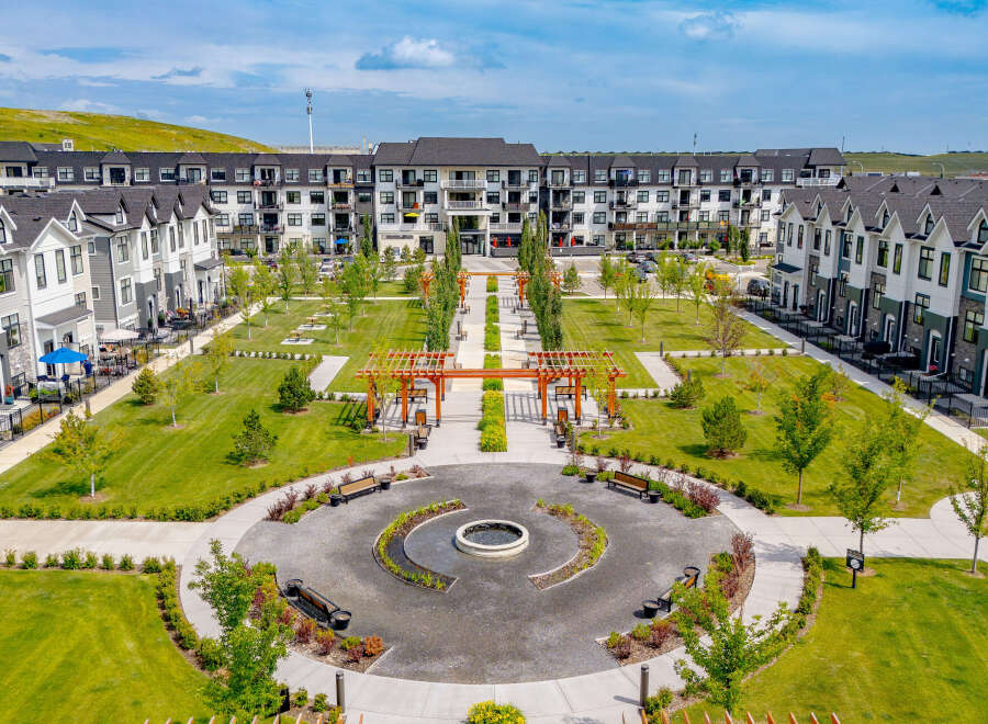 Discover modern living in this stunning community featuring a central courtyard with a water feature and ample green space for relaxation.