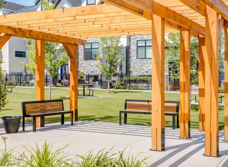 Enjoy outdoor living under this beautiful wooden pergola, perfect for relaxing or entertaining.