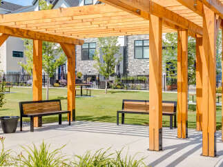 Enjoy outdoor living under this beautiful wooden pergola, perfect for relaxing or entertaining.