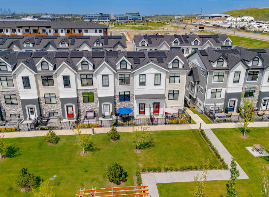 Discover modern townhome living with these beautifully designed residences featuring sleek architecture and solar panels for sustainable energy.
