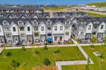 Discover modern townhome living with these beautifully designed residences featuring sleek architecture and solar panels for sustainable energy.