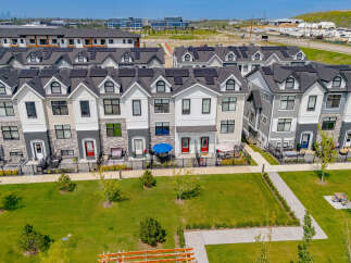 Discover modern townhome living with these beautifully designed residences featuring sleek architecture and solar panels for sustainable energy.