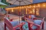 Experience the ultimate mountain retreat with this charming log cabin's expansive deck, perfect for outdoor entertaining.