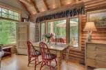Experience rustic charm in this cozy dining area, featuring a wooden table with red chairs perfect for intimate meals.