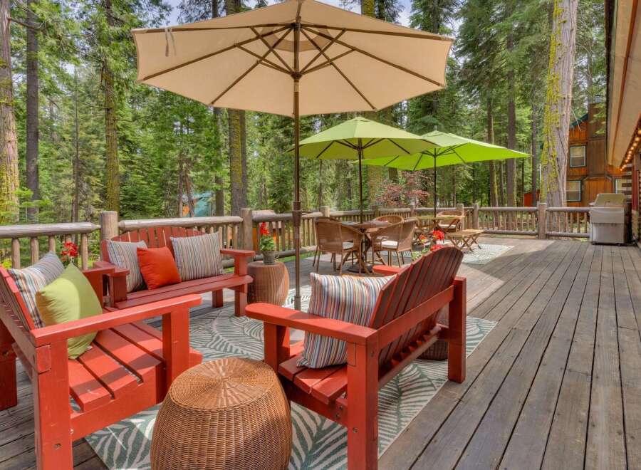 Enjoy the serene mountain setting from this expansive wooden deck, perfect for outdoor entertaining.