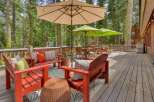 Enjoy the serene mountain setting from this expansive wooden deck, perfect for outdoor entertaining.