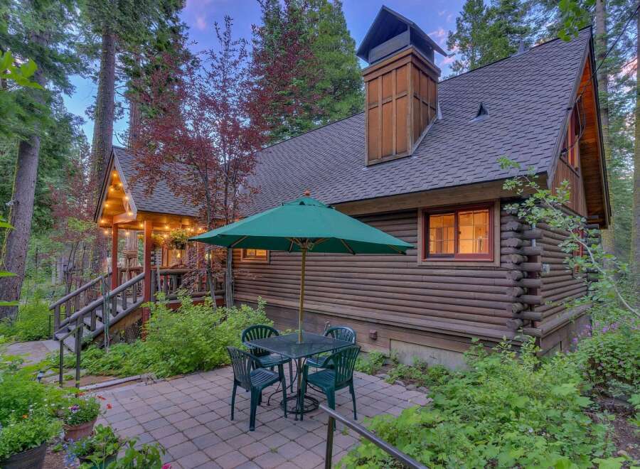 Experience rustic charm in this log cabin nestled amongst tall trees.