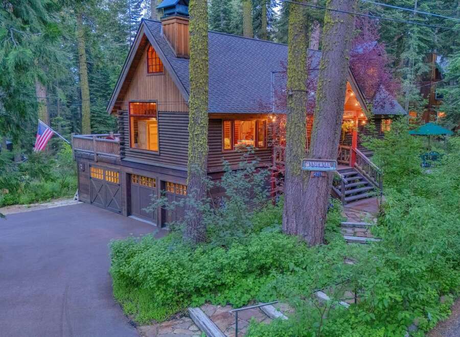 Nestled amidst towering trees, this charming log cabin offers a serene mountain retreat.