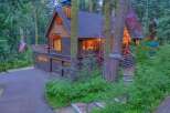 Nestled amidst towering trees, this charming log cabin offers a serene mountain retreat.