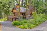 Nestled amidst towering trees, this charming log cabin offers a serene mountain retreat.