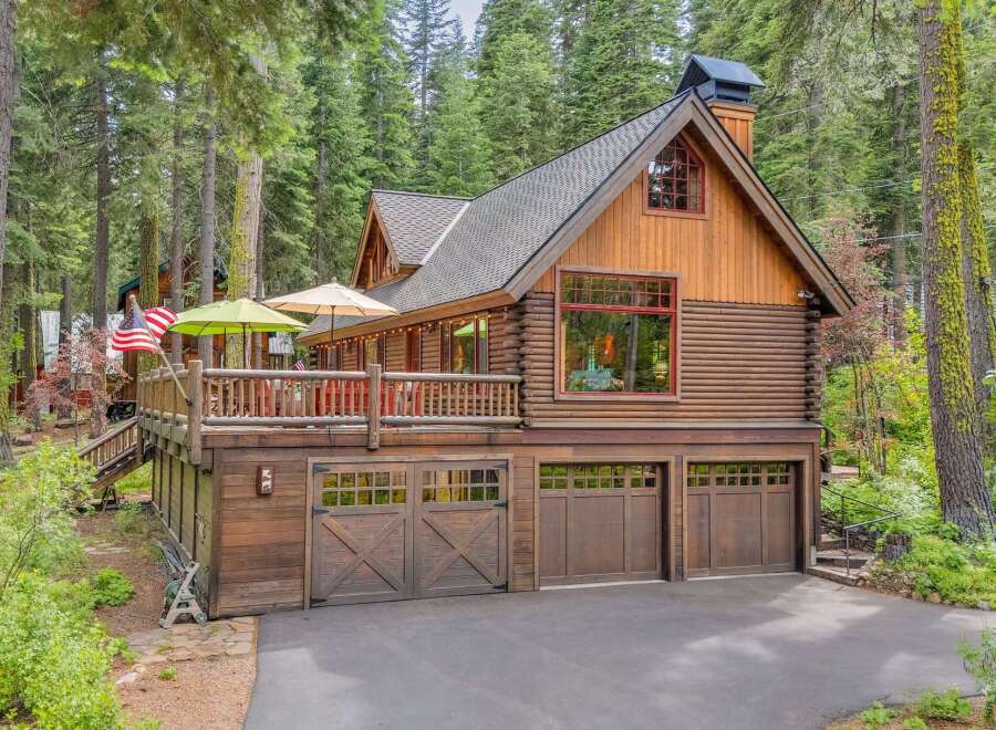 Experience rustic charm in this stunning log cabin nestled amongst tall pine trees.