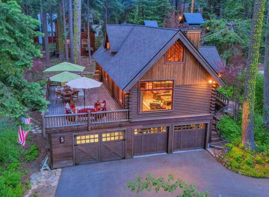 Experience rustic charm in this stunning log cabin home, nestled amidst towering trees.