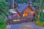 Experience rustic charm in this stunning log cabin home, nestled amidst towering trees.