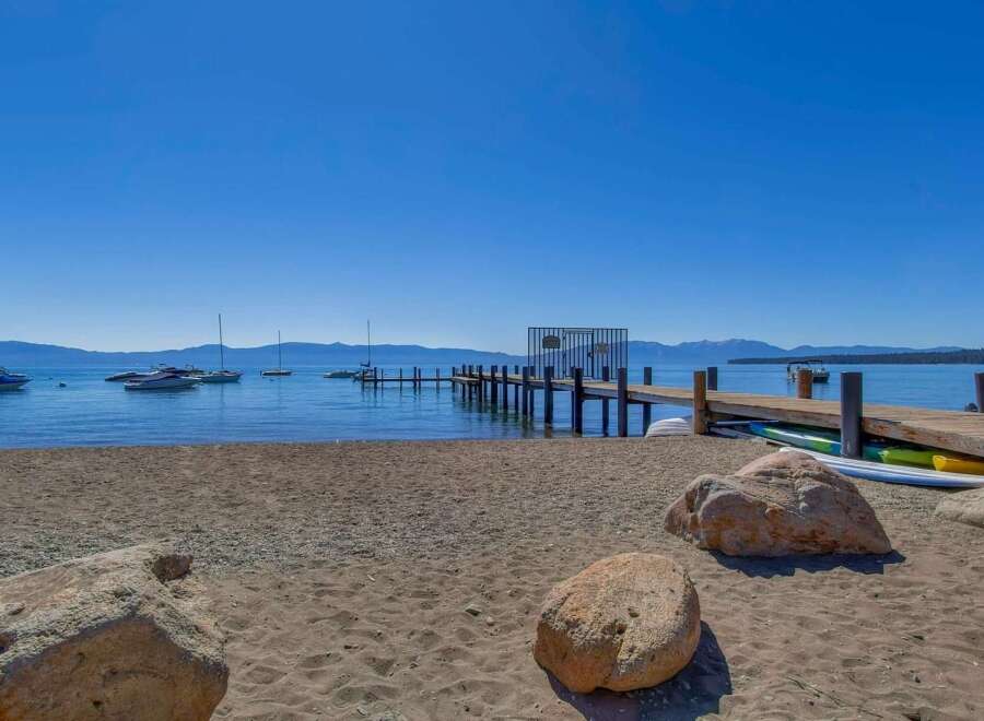 Enjoy lakeside living with this stunning property featuring a private dock and beach access.