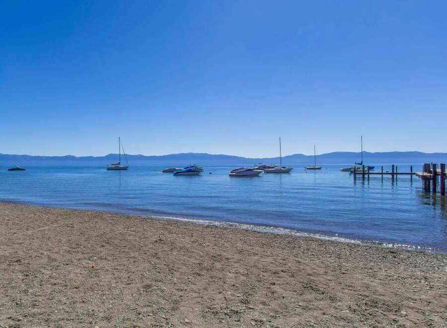 Enjoy breathtaking lake views from this stunning property, complete with a private beach and a convenient dock for your watercraft.