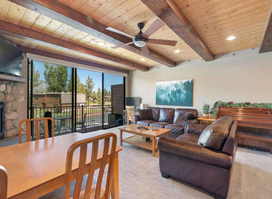 Experience cozy living in this spacious room featuring a stone fireplace and a large dining area.