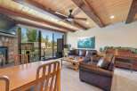 Experience cozy living in this spacious room featuring a stone fireplace and a large dining area.
