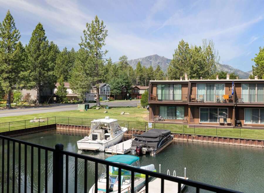 Enjoy waterfront living with this stunning property featuring a private dock and boat slips, perfect for water enthusiasts.