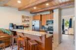 Experience the charm of this kitchen featuring warm wood cabinetry and a granite-topped breakfast bar, perfect for casual dining.