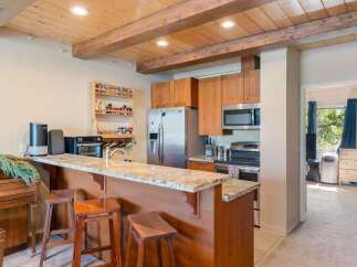 Experience the charm of this kitchen featuring warm wood cabinetry and a granite-topped breakfast bar, perfect for casual dining.