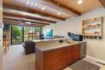 Experience comfortable living in this inviting space featuring a well-equipped kitchenette with ample cabinet storage and a granite countertop.